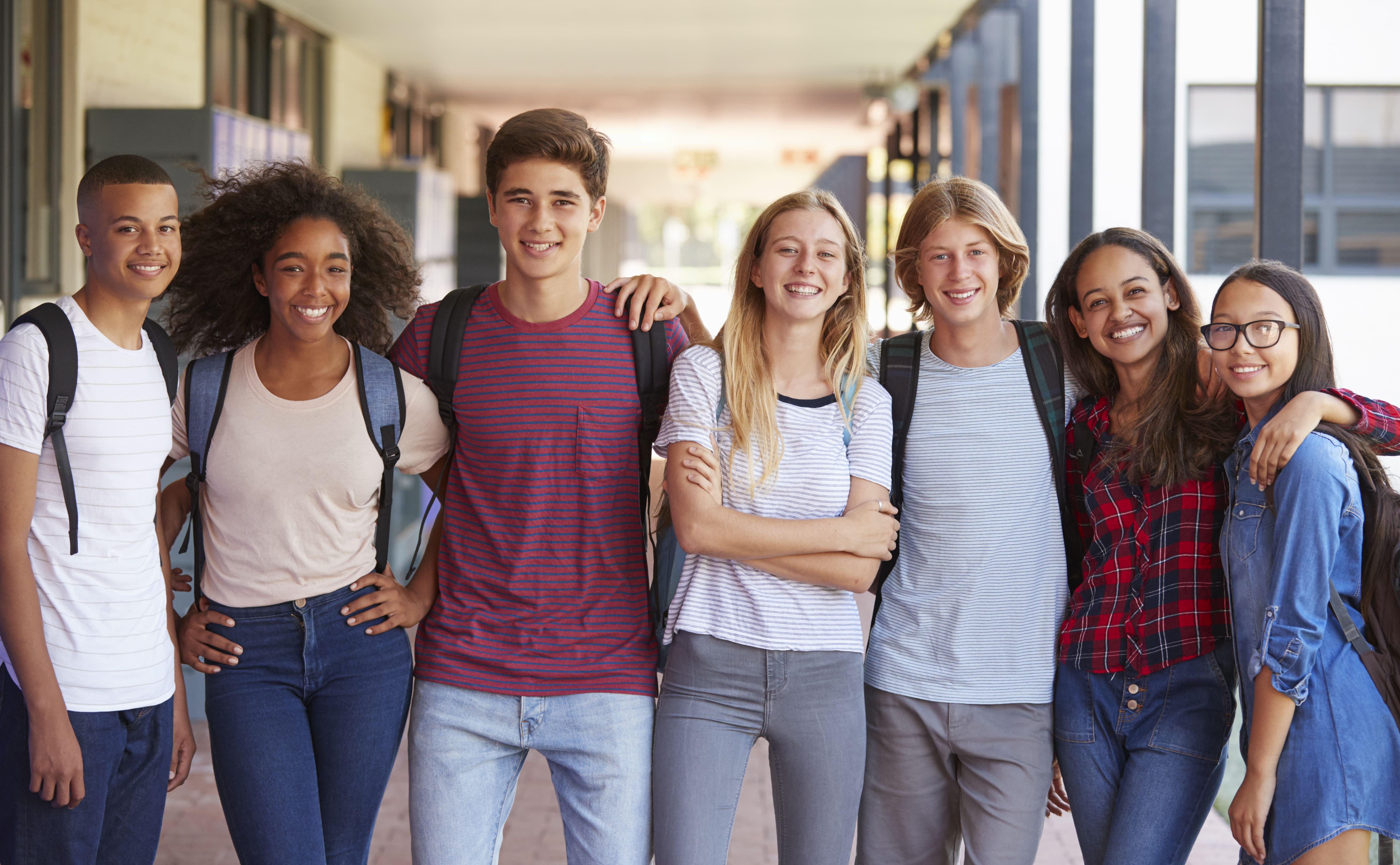 teenage-classmates-standing-in-high-school-hallway
